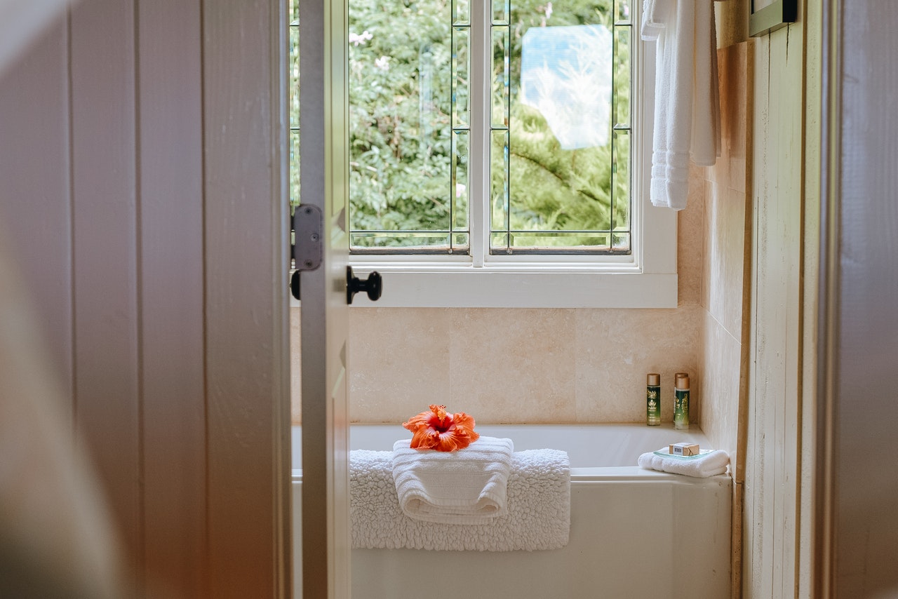 prevent mold in bathroom -- bathroom with towels on bathtub and windows open
