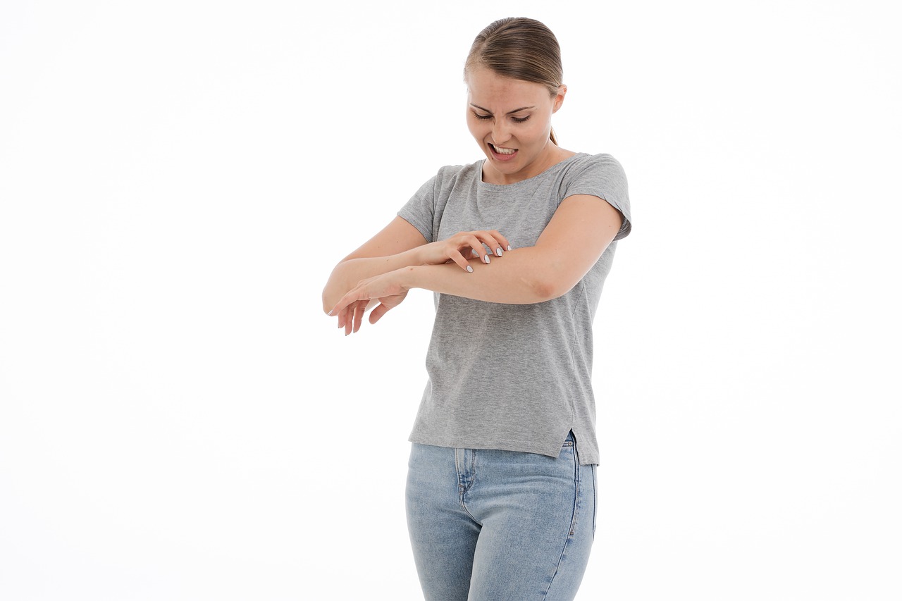 mold rash -- woman scratching her arm