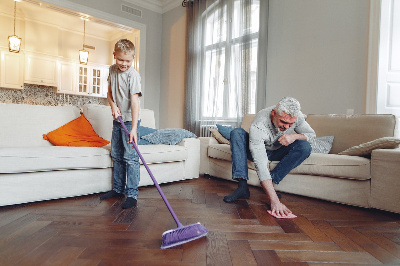 how to clean mold -- older man and young boy cleaning a living room